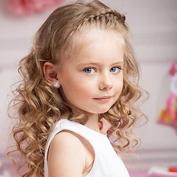 Child model  wearing unicorn earrings